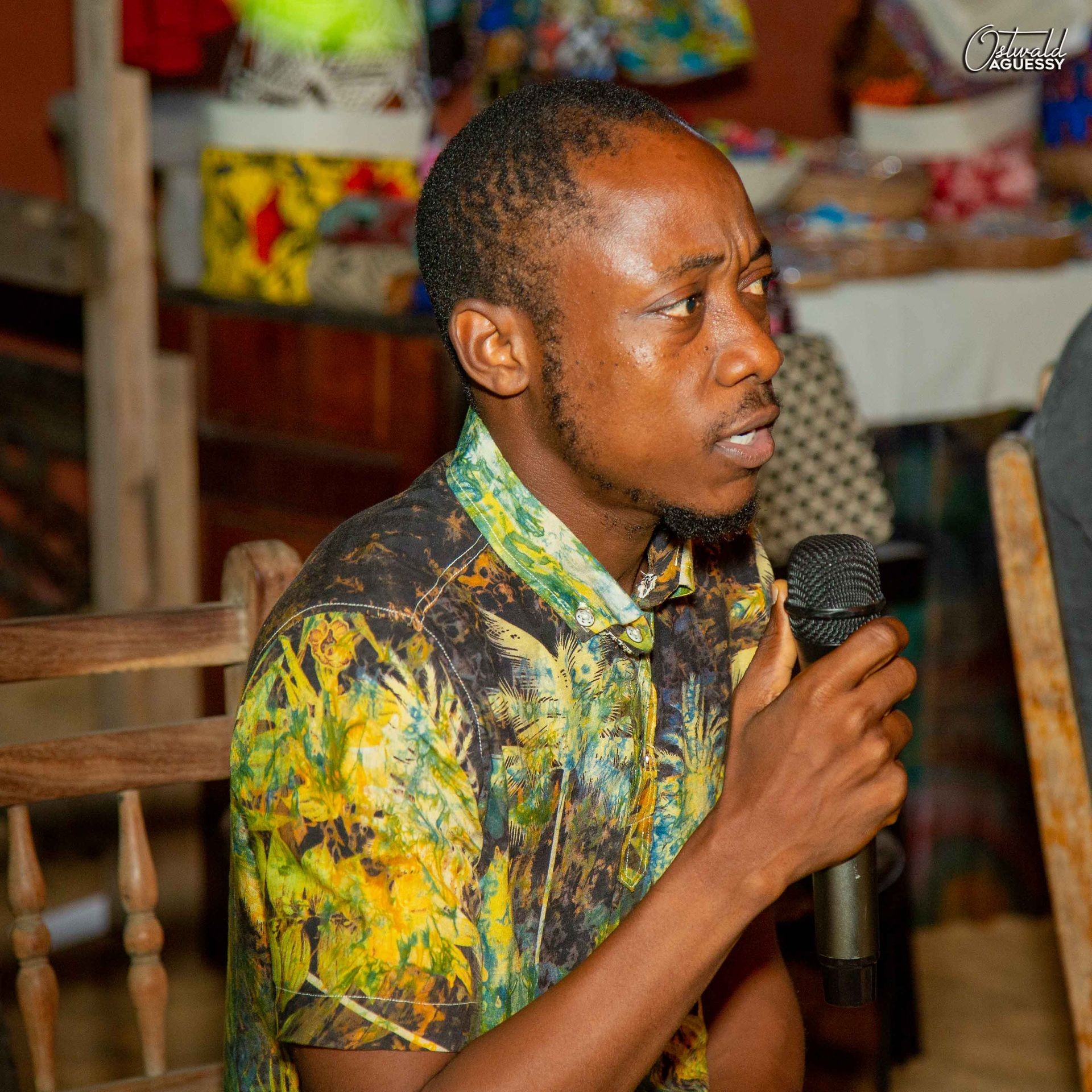 A person speaking with a mic in his hand