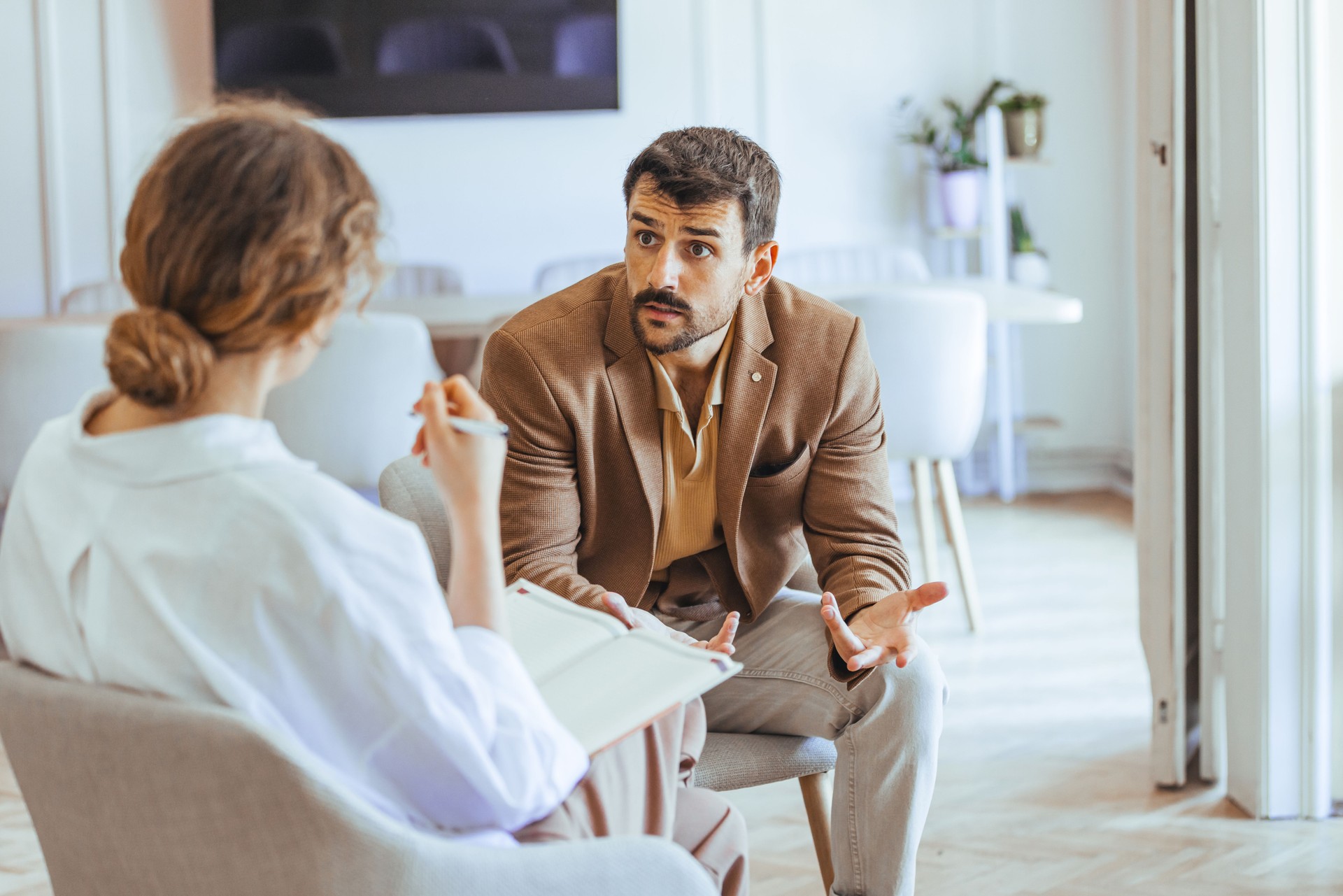 Man Engaged in Conversation During a Professional Counseling or Therapy Session